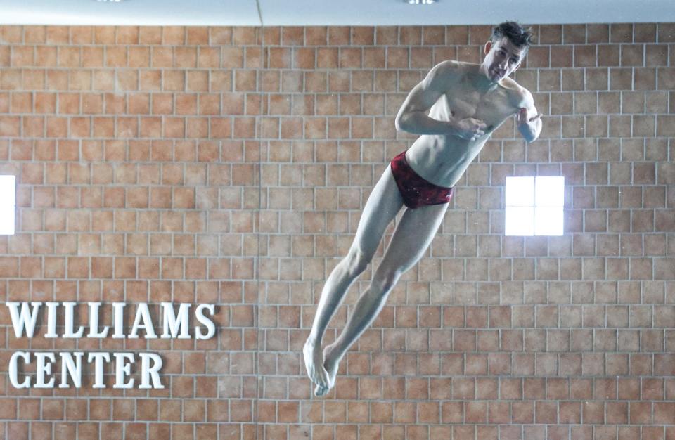 Bedford's Austin Clise performs his second round dive during the Monroe County Championship Saturday, February 4, 2023 at Dundee High School. He won the event.