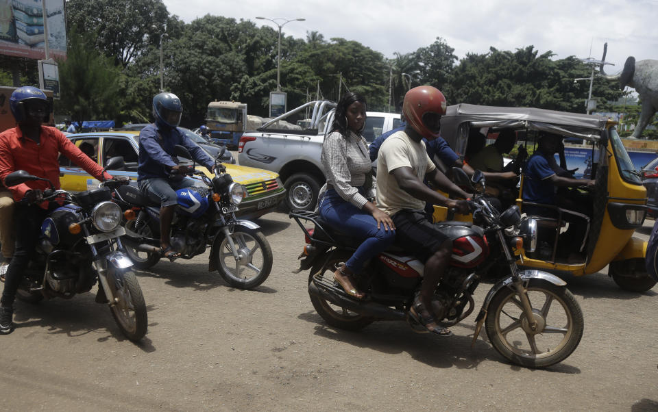 Motorcycle taxi and cars during rush hour in Conakry, Guinea Thursday, Sept. 9, 2021. Guinea's new military leaders sought to tighten their grip on power after overthrowing President Alpha Conde, warning local officials that refusing to appear at a meeting convened Monday would be considered an act of rebellion against the junta. (AP Photo/ Sunday Alamba)