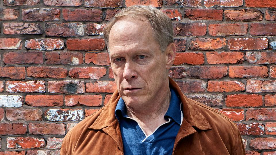 Coronation Street killer Stephen Reid looking menacing in front of a brick wall background