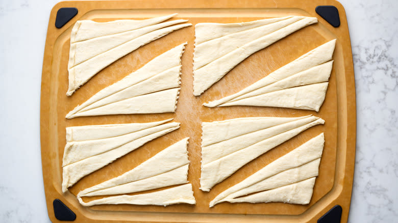 triangle-sliced crescent dough on board