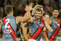 Jobe Watson of the Bombers is congratulated by team mates after kicking a goal.