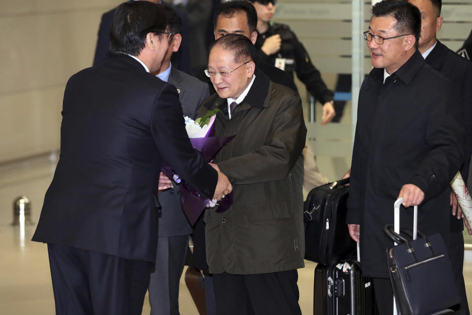 North Korean vice chairman of the Korea Asia-Pacific Peace Committee Ri Jong Hyok, second from left, is greeted by an unidentified South Korean officer upon his arrival at the Incheon International Airport in Incheon, South Korea, Wednesday, Nov. 14, 2018. A five-member North Korean delegation is visiting South Korea to attend an academic forum on Japan's wartime actions. (Kim In-chul/Yonhap via AP)