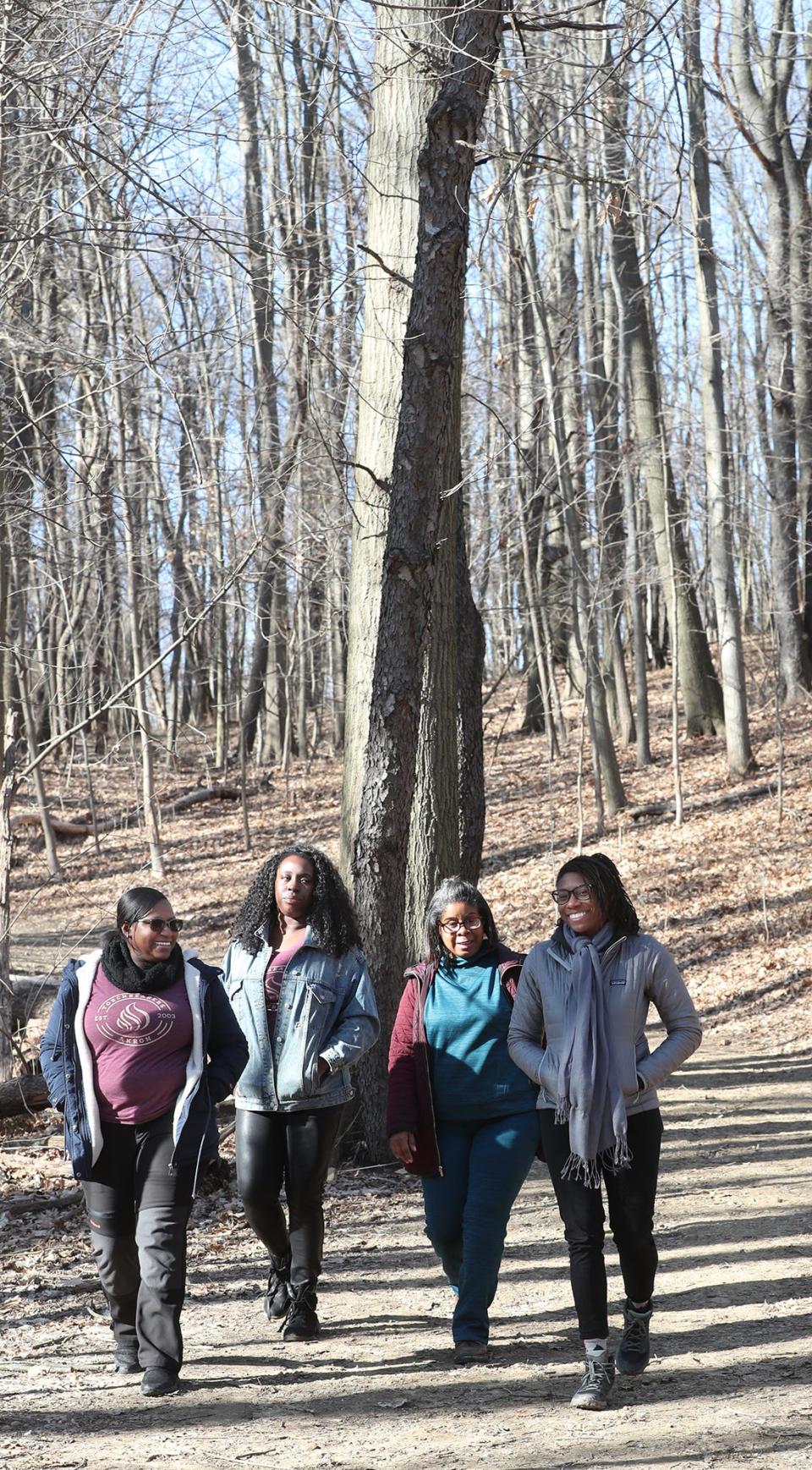 Members of Black Women Explore, from left Rachelle Yarbrough, Vinga Hart, Traci Lewis and Bronlynn Thurman converses during a short walk at Goodyear Heights Metro Park in Akron.