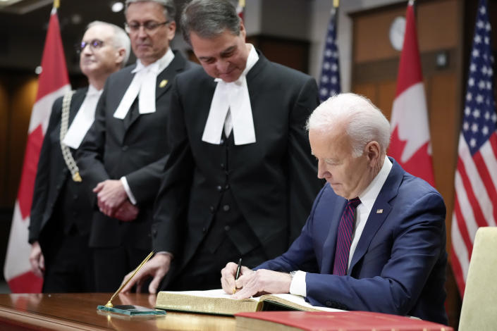 President Joe Biden participates in a guest book signing at Parliament Hill, Friday, March 24, 2023, in Ottawa, Canada. (AP Photo/Andrew Harnik)