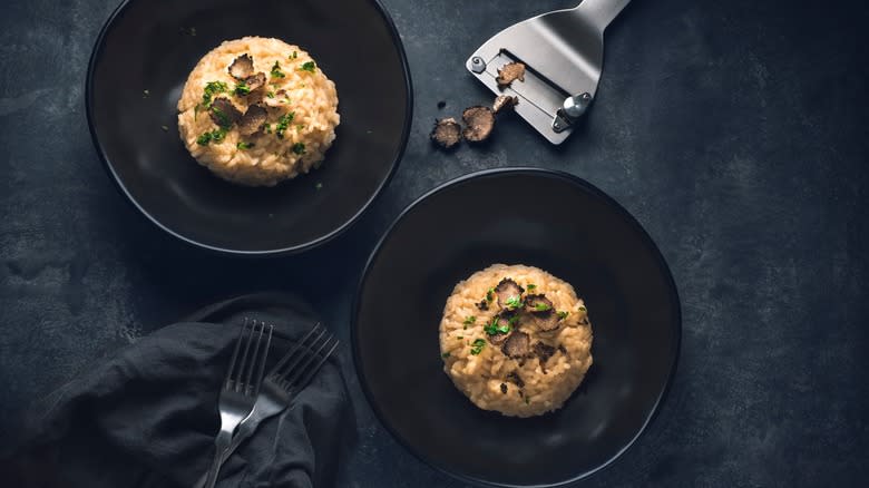 Truffle risotto on two black plates