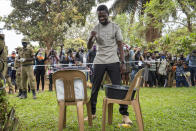 Uganda's leading opposition challenger Bobi Wine reacts after voting in Kampala, Uganda, Thursday, Jan. 14, 2021. Ugandans are voting in a presidential election tainted by widespread violence that some fear could escalate as security forces try to stop supporters of Wine from monitoring polling stations.(AP Photo/Jerome Delay)