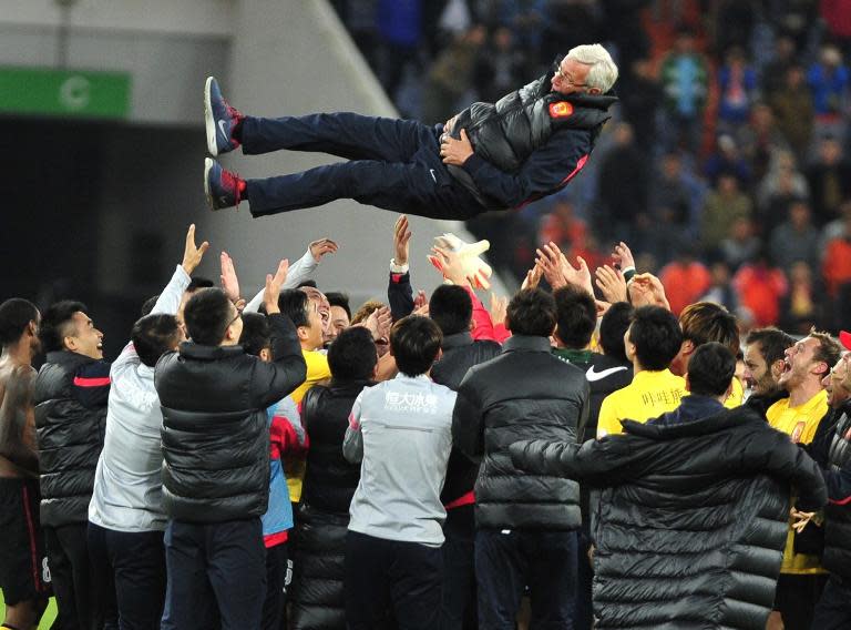 Guangzhou Evergrande's coach Marcello Lippi is thrown into the air as the club's players celebrate winning their 4th Chinese Super League title, in Jinan, east China's Shandong province, on November 2, 2014