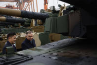 South Korea's Defense Acquisition Program Administration Minister Eom Dong-hwan, left, and Polish President Andrzej Duda, right, inspects the South Korean Black Panther K2 tank in the Polish Navy port of Gdynia, Poland, Tuesday, Dec. 6, 2022. Poland's President Andrzej Duda and the defense minister on Tuesday welcomed the first delivery of tanks and howitzers from South Korea, hailing the swift implementation of a deal signed in the summer in the face of the war in neighbouring Ukraine. (AP Photo/Michal Dyjuk)