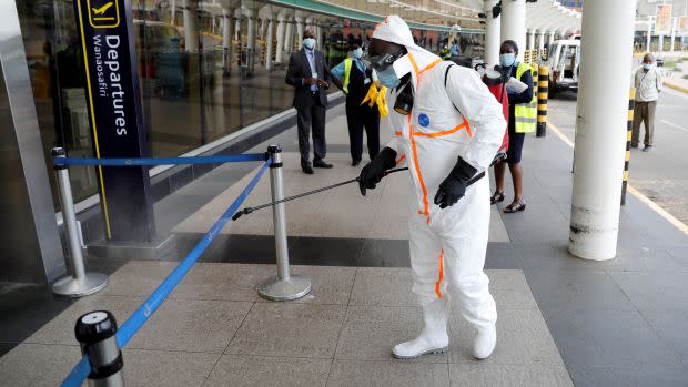 A health worker sprays disinfectant to prevent a Covid-19 outbreak at the Jomo Kenyatta International Airport in Nairobi, Kenya.