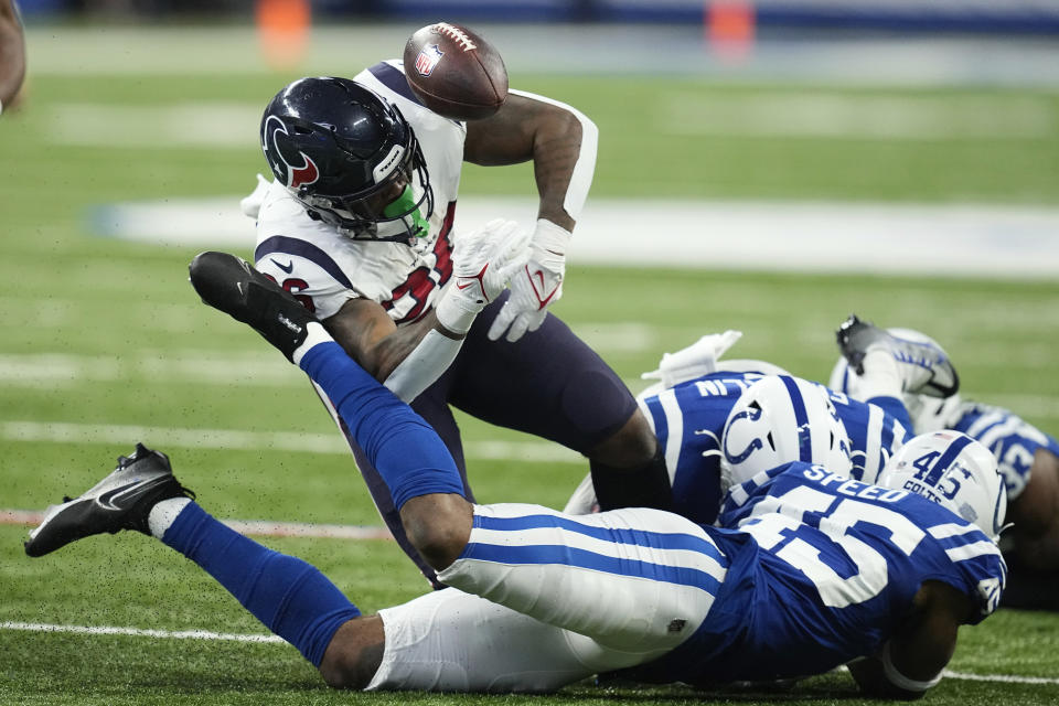 Houston Texans running back Royce Freeman (26) fumbles the ball after being tackled during the first half of an NFL football game between the Houston Texans and Indianapolis Colts, Sunday, Jan. 8, 2023, in Indianapolis. (AP Photo/Darron Cummings)