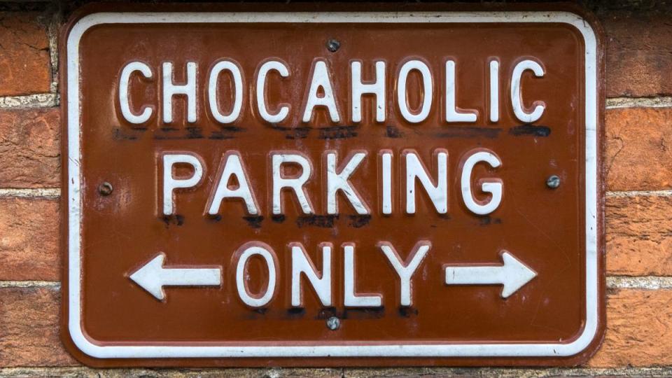 Close-up of a fun sign informing people that the parking spaces are for Chocaholics only. (Funny road signs )