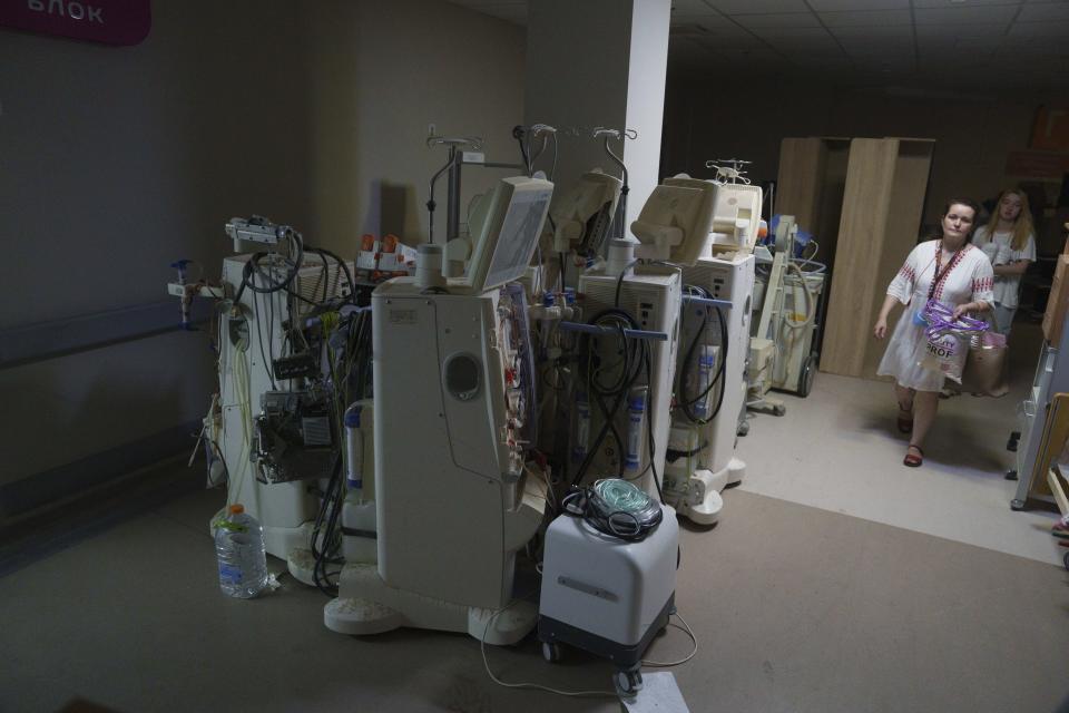 Women walk along a corridor inside the Okhmatdyt children's hospital a day after it was hit by Russian, in Kyiv, Ukraine, Tuesday, July 9, 2024. (AP Photo/Evgeniy Maloletka)