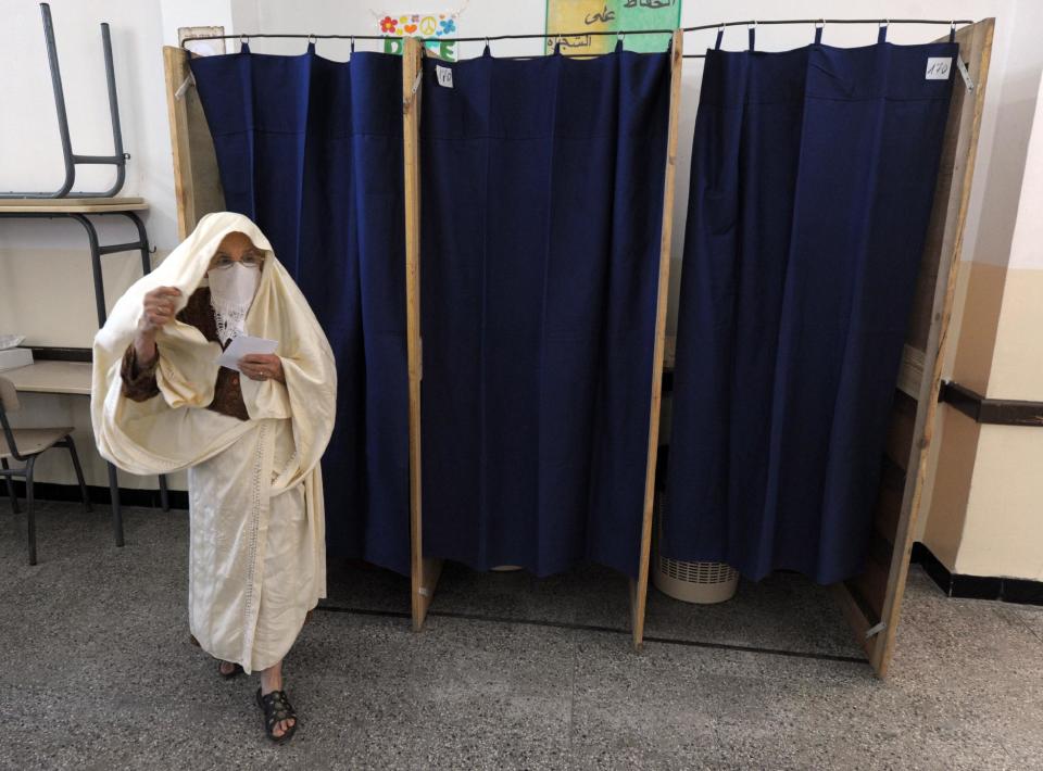 An Algerian woman exits a voting booth before casting her ballot in the presidential elections in Algiers, Thursday, April 17, 2014. Algerians trickled into voting booths on a sunshine-drenched Thursday to elect the president of this oil-rich North African nation in an election dominated by the ailing incumbent running for a fourth term. (AP Photo/Sidali djarboub)