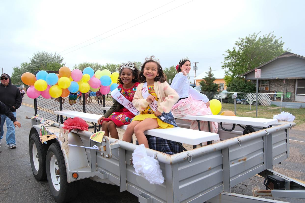 Local young beauty queens of Amarillo and Potter County ride past the crowd at the Cinco de Mayo Parade Saturday in Amarillo.