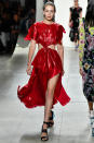 <p>Gigi's abs stole the show in this red dress at Prabal Gurung.</p>