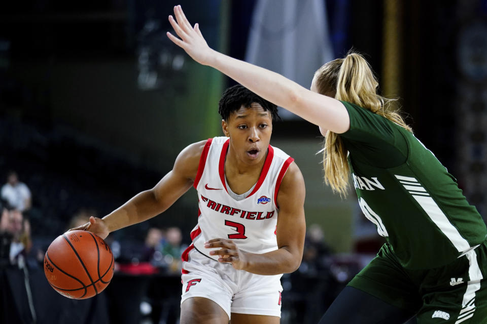 FILE - Fairfield's Janelle Brown, left, dribbles the ball as Manhattan's Sini Mȁkelȁ defends in the first half of an NCAA college basketball game during the championship of the Metro Atlantic Athletic Conference tournament, Saturday, March 12, 2022, in Atlantic City, N.J. Brown, the Metro Atlantic Athletic Conference player of the year, has helped Fairfield (31-1) win 29 consecutive games. (AP Photo/Matt Rourke, File)