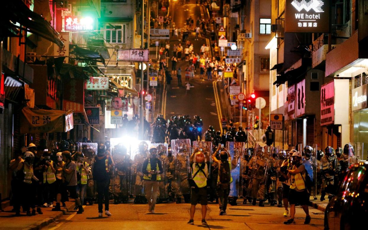 Police officers line up in Hong Kong during a protest in July - Edgar Su /Reuters 