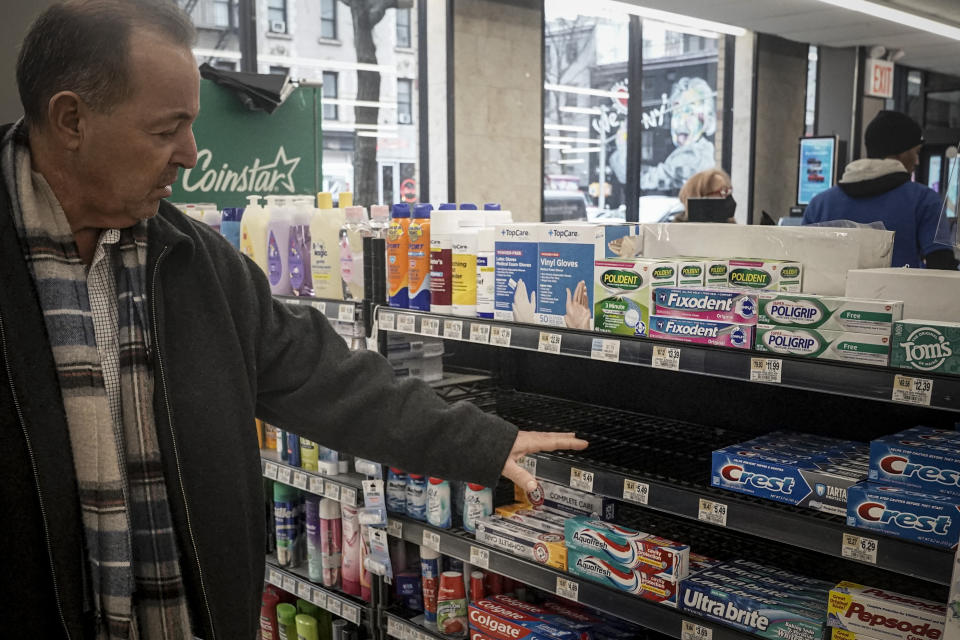 Dominick Albrego, director of security for Gristedes and D'Agostino supermarkets and former police officer, checks a shelf in the health and beauty section for missing products "swept up" in a suspected theft, Tuesday Jan. 31, 2023, in New York. The section was moved closer to the front of the store to curtail theft. (AP Photo/Bebeto Matthews)