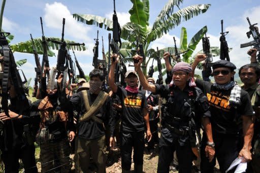 A file photo of Ameril Umbrakato (3rd R-front), leader of the breakaway Muslim separatist group Bangsamoro Islamic Freedom Fighters (BIFF), holding a pistol and shouting "Allah Akbar" with his men on Mindanao. The BIFF launched simultaneous attacks across 11 towns in the southern Philippines on August 6, 2012