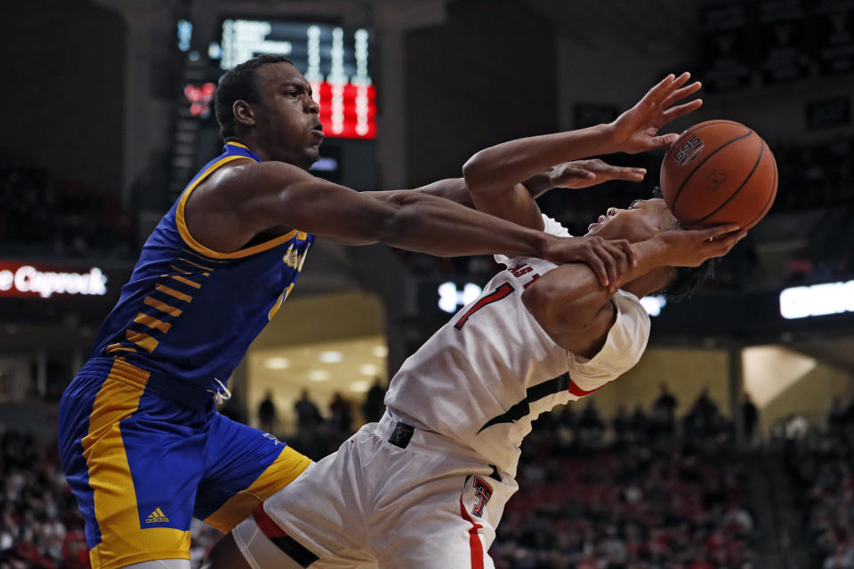 Cal State Bakersfield's Ronne Readus (0) fouls Texas Tech's Terrence Shannon Jr. (1) who tries to shoot during the first half of an NCAA college basketball game Sunday, Dec. 29, 2019, in Lubbock, Texas. (AP Photo/Brad Tollefson)