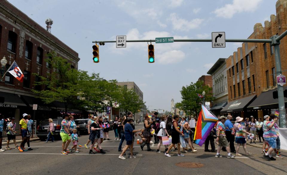 Participants kick off the 2023 Stark Pride Festival on Saturday with a pride walk, crossing Cleveland Avenue in downtown Canton.