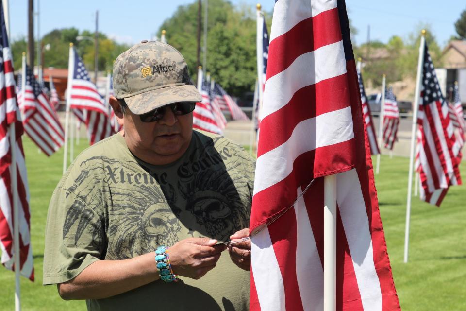 David L. Tom searches for a flag displaying information about his son, Army Sgt. Troy Orion Tom, who died in Afghanistan in 2009. Tom visited the Flags of Remembrance: Healing Field display at the Boys & Girls Clubs of Farmington on May 28, 2021.