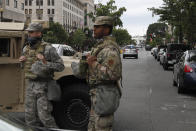 Members of the DC National Guard block an intersection on 16th Street as demonstrators gather to protest the death of George Floyd, Tuesday, June 2, 2020, near the White House in Washington. Floyd died after being restrained by Minneapolis police officers. (AP Photo/Jacquelyn Martin)