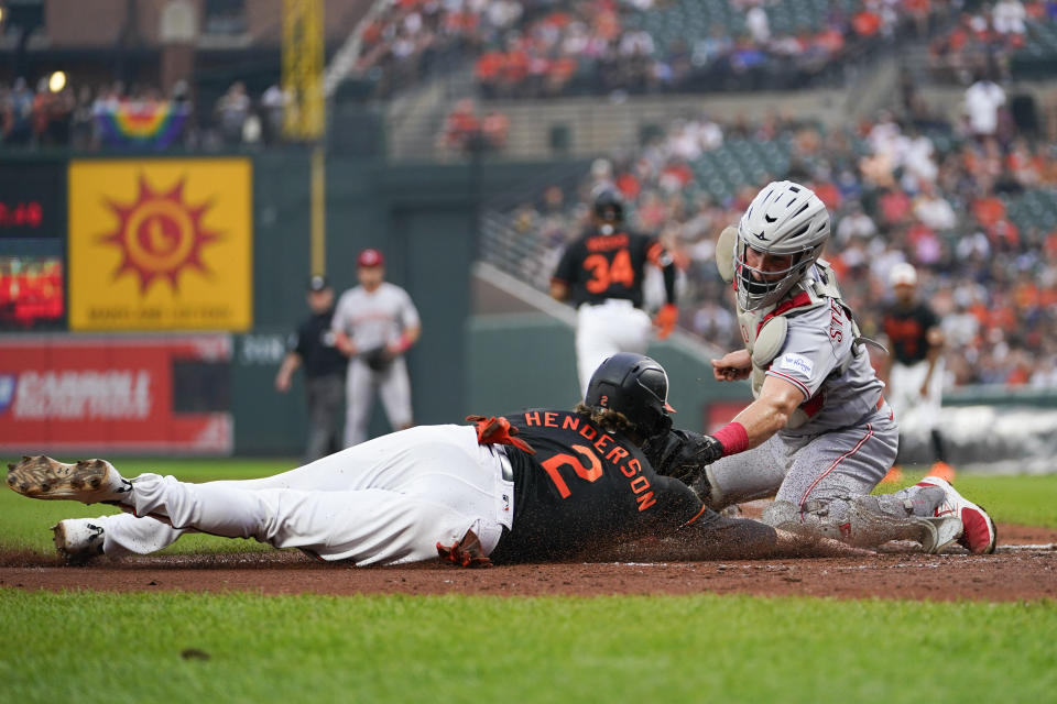 Cincinnati Reds catcher Tyler Stephenson, right, tags out Baltimore Orioles' Gunnar Henderson trying to score on a fielder's choice ground ball hit by Aaron Hicks in the first inning of a baseball game, Wednesday, June 28, 2023, in Baltimore. (AP Photo/Julio Cortez)