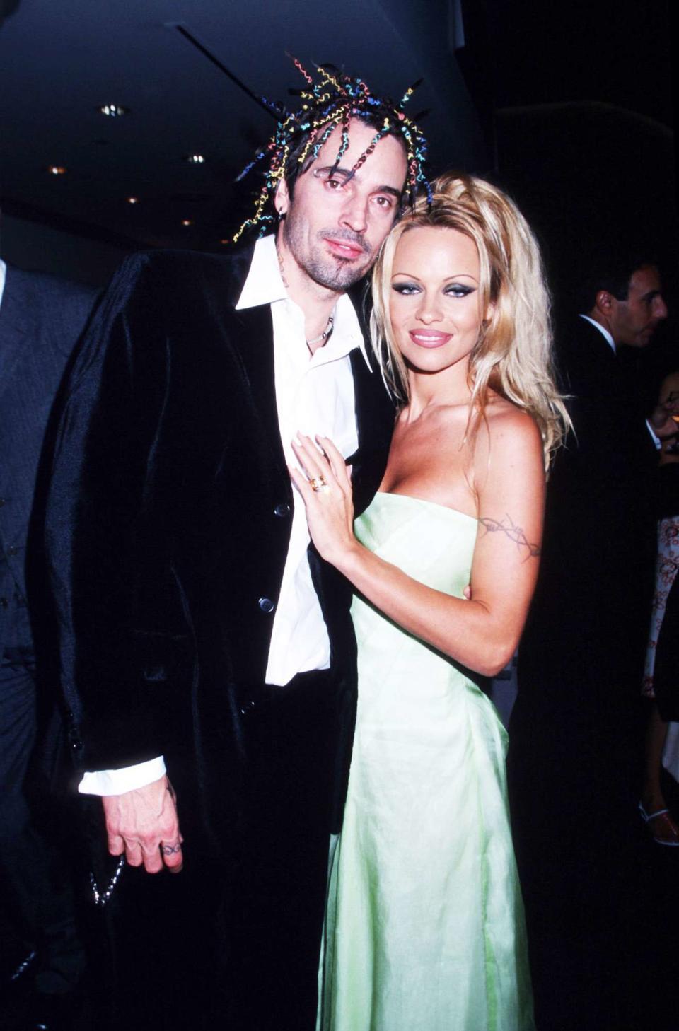 Pamela Anderson Lee stands with husband Tommy Lee at PETA's Milennium Gala September 18, 1999 at Paramount Studios in Los Angeles, California. Lee got her start in Labatt's beer commercials before starring in Baywatch