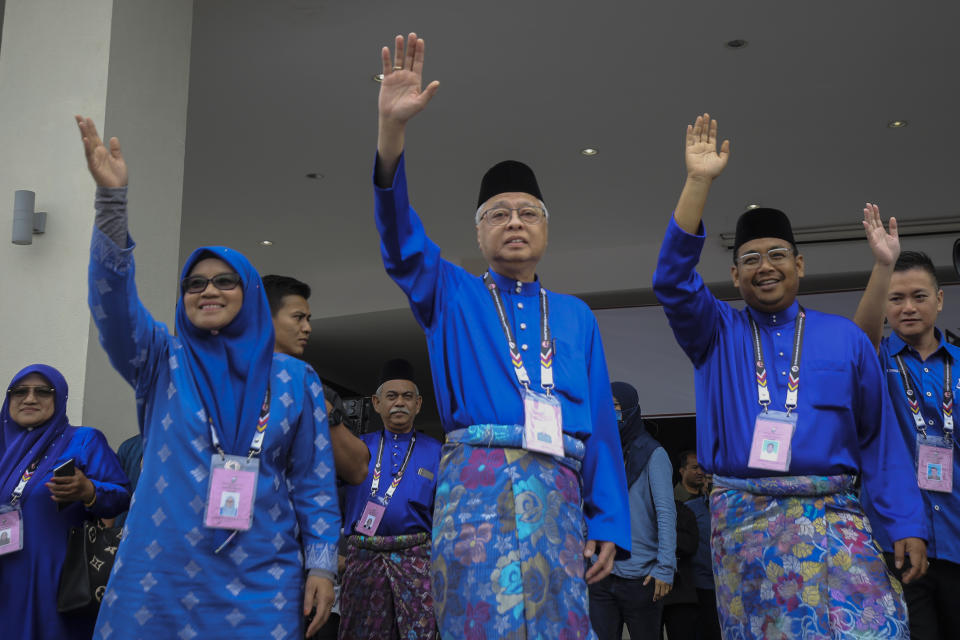 Malaysian Prime Minister Ismail Sabri Yaakob, center, waves to his supporters after his nomination documents were accepted for the upcoming general election in Bera, Pahang, Malaysia, Saturday, Nov. 5, 2022. (AP Photo/Ahmad Yusni)
