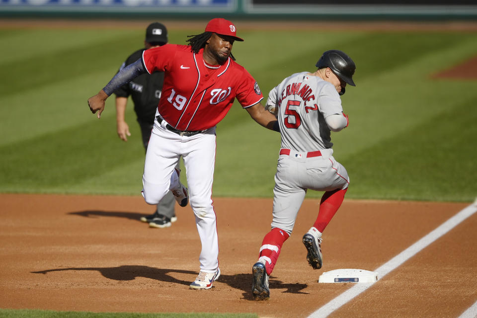 Boston Red Sox's Enrique Hernandez (5) is out at first against Washington Nationals first baseman Josh Bell (19) during the first inning of a baseball game Saturday, Oct. 2, 2021, in Washington. (AP Photo/Nick Wass)