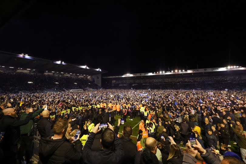 A Barnsley player was attacked after Portsmouth fans invaded the pitch in celebration of their side's promotion to the Championship