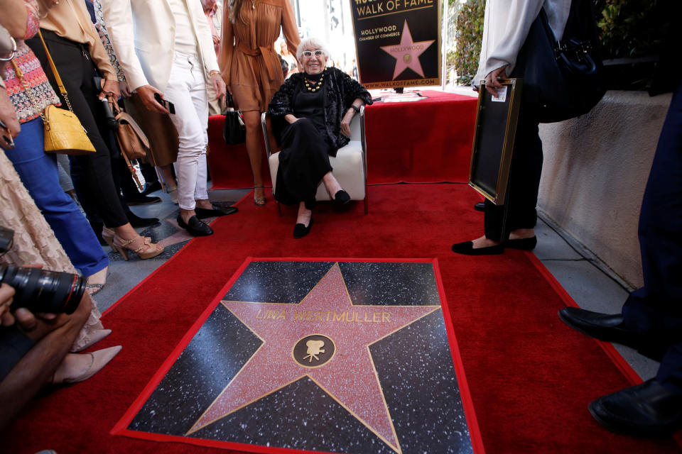 <p>Italian director Lina Wertmuller poses by her star after it was unveiled on the Hollywood Walk of Fame in Los Angeles, California, U.S., October 28, 2019. REUTERS/Mario Anzuoni</p> 