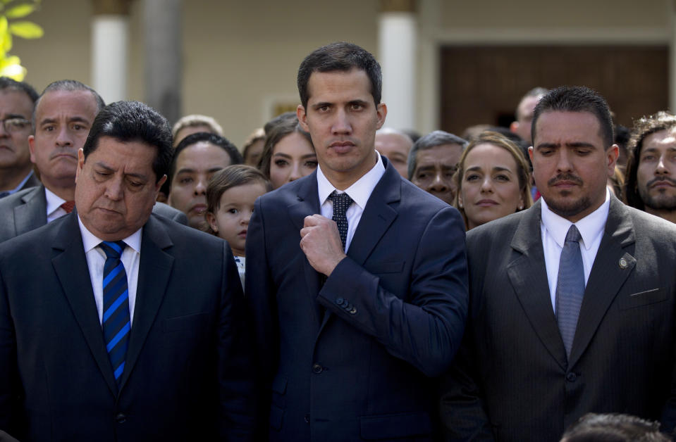 FILE - In this Jan. 5, 2019 file photo, newly-sworn-in National Assembly President Juan Guaidó, center, poses for a group photo with fellow lawmakers, in Caracas, Venezuela. The legislature installed the 35-year-old as president of the opposition-controlled congress. Guaidó called President Nicolás Maduro a dictator. (AP Photo/Fernando Llano)
