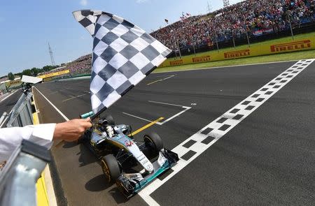 Mercedes AMG Petronas F1 Team's British driver Lewis Hamilton crosses the finish line to win the Formula One Hungarian Grand Prix at the Hungaroring circuit in Mogyorod near Budapest, Hungary, on July 24, 2016. REUTERS/ANDREJ ISAKOVIC/Pool