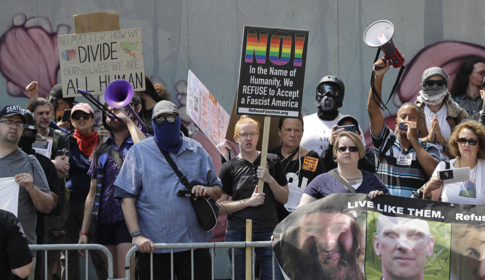 Counter-protesters gather across the street from a rally held by members of Patriot Prayer and other groups advocating for gun rights, Saturday, Aug. 18, 2018, in front of City Hall in Seattle. (AP Photo/Ted S. Warren)