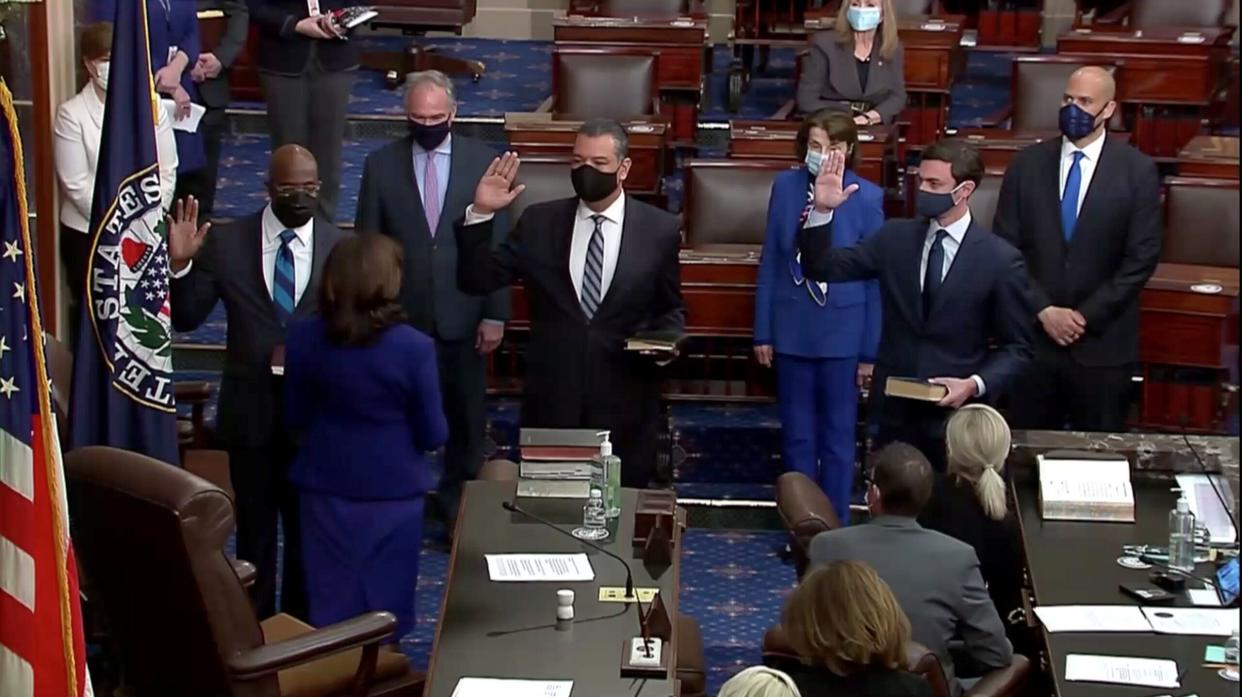 (Left to right) Democrats Raphael Warnock, Alex Padilla and Jon Ossoff take the oath of office administered by Vice President Kamala Harris in the Senate chamber on Wednesday. The three new senators and Harris' role as the Senate's presiding officer established Democrats as the chamber's majority. (Photo: Senate TV via REUTERS)