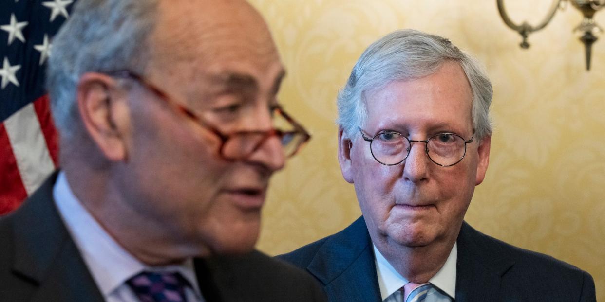 Senate Minority Leader Mitch McConnell stands behind Senate Majority Leader Chuck Schumer at a ceremony at the Capitol on June 8, 2022.