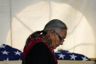 Ione Quigley, the Rosebud Sioux's historic preservation officer, returns to her seat after speaking during a ceremony at the U.S. Army's Carlisle Barracks, in Carlisle, Pa., Wednesday, July 14, 2021. The disinterred remains of nine Native American children who died more than a century ago while attending a government-run school in Pennsylvania were headed home to Rosebud Sioux tribal lands in South Dakota on Wednesday after a ceremony returning them to relatives. (AP Photo/Matt Rourke)