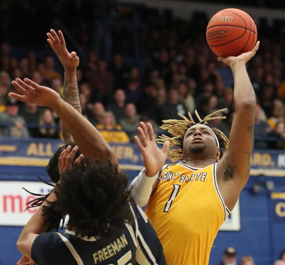 Akron's Greg Tribble and Enrique Freeman defend against Kent State's VonCameron Davis at the MAC Center in Kent.