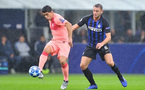 Luis Suarez of FC Barcelona competes with Stefan de Vrij of FC Internazionale during the Group B match of the UEFA Champions League between FC Internazionale and FC Barcelona - Credit: GETTY IMAGES