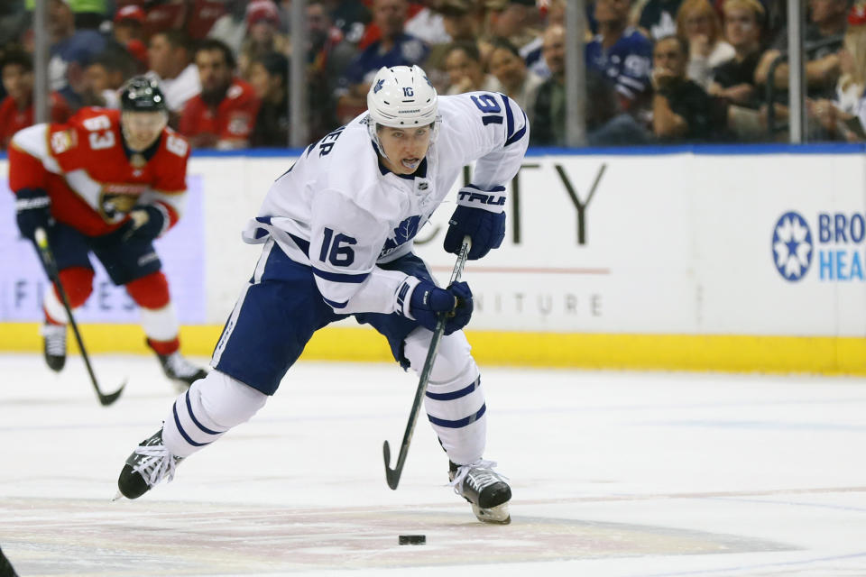 Toronto Maple Leafs right wing Mitchell Marner (16) takes the puck down the ice against Florida Panthers right wing Evgenii Dadonov (63) during the first period of an NHL hockey game, Sunday, Jan. 12, 2020, in Sunrise, Fla. (AP Photo/Wilfredo Lee)