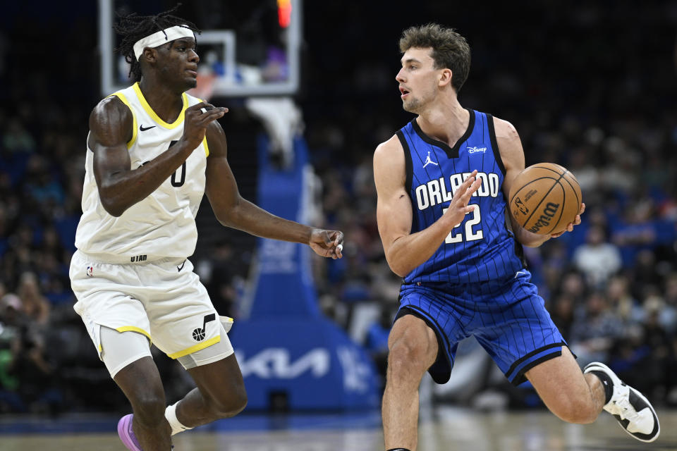 Orlando Magic forward Franz Wagner, right, is defended by Utah Jazz forward Taylor Hendricks, left, during the first half of an NBA basketball game, Thursday, Feb. 29, 2024, in Orlando, Fla. (AP Photo/Phelan M. Ebenhack)