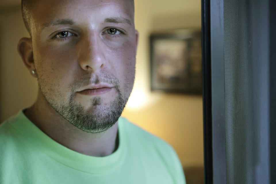 In this Monday, Oct. 1, 2018 photo Michael Robinson, of North Reading, Mass., in recovery from heroin addiction, stands for a photo at his mother's apartment, in North Reading. Robinson recently became a union carpenter and has been working on building projects across the Boston area since. In Massachusetts, with Medicaid expansion already paying for opioid addiction treatment, emergency money from Congress goes largely toward recovery services. (AP Photo/Steven Senne)