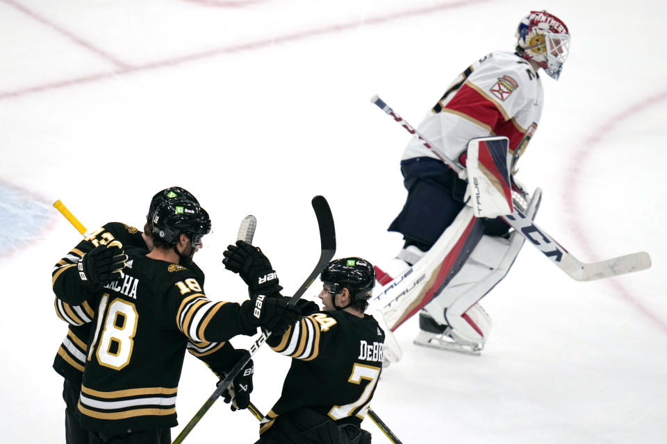 Boston Bruins center Pavel Zacha (18) is congratulated after his winning goal against the Florida Panthers in an overtime period of an NHL hockey game, Monday, Oct. 30, 2023, in Boston. (AP Photo/Charles Krupa)