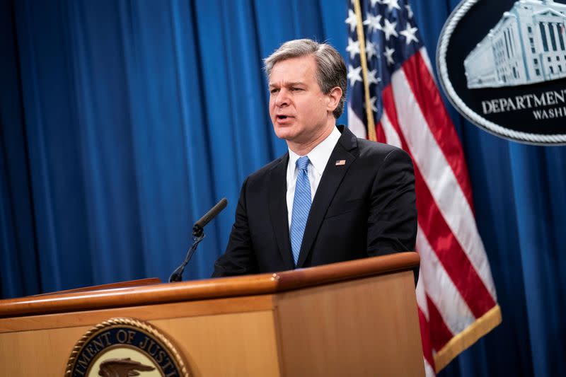 FBI Director Christopher Wray attends a virtual news conference at the Department of Justice in Washington