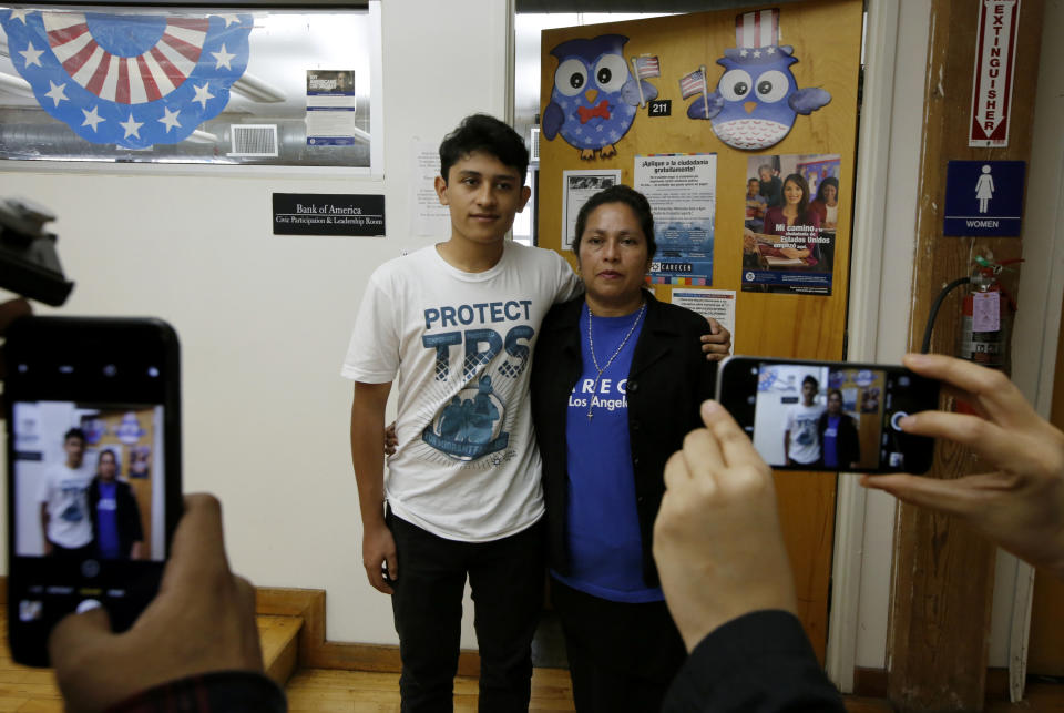 <p>U.S. citizen Benjamin Zepeda, 14, with his mother Lorena Zepeda, who benefits from Temporary Protected Status have their photo taken after a news conference in Los Angeles, Monday, Jan. 8, 2018. (Photo: Damian Dovarganes/AP) </p>