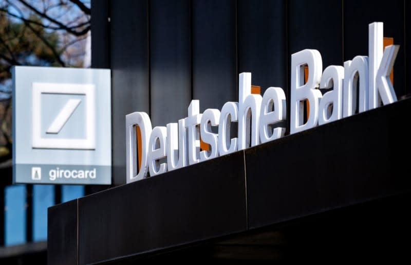 The Deutsche Bank logo is pictured above the entrance of a branch in Oldenburg city center. Hauke-Christian Dittrich/dpa