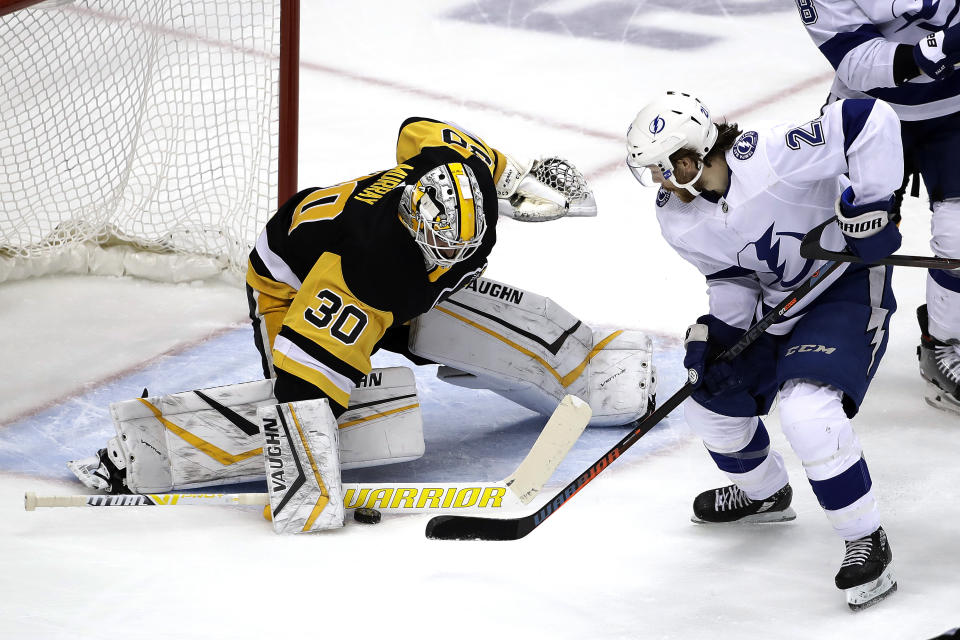 Pittsburgh Penguins goaltender Matt Murray (30) stops a shot by Tampa Bay Lightning's Brayden Point (21) during the first period of an NHL hockey game in Pittsburgh, Tuesday, Feb. 11, 2020. (AP Photo/Gene J. Puskar)