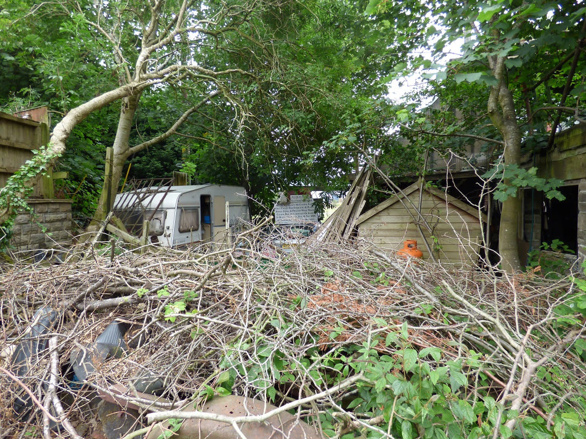 The home of a former television star known as the 'King of the Eccentrics' has been put up for auction - including the garden where his body is buried. See SWNS story SWLNjake; Jake Mangle-Wurzel was a notorious hoarder who died with a large number of quirky items abandoned at his property. This included wacky inventions, torture devices and headless mannequins. Jake died last year at the age of 83, after a short battle with skin cancer and was laid to rest within the grounds of the home in Huddersfield, West Yorks,. He rose to fame in the 1980s and appeared on various television shows throughout the years, including a documentary about himself that was aired in 2015.  His house in Huddersfield, West Yorks,. has now gone up for auction for a guide price of £75,000. 
